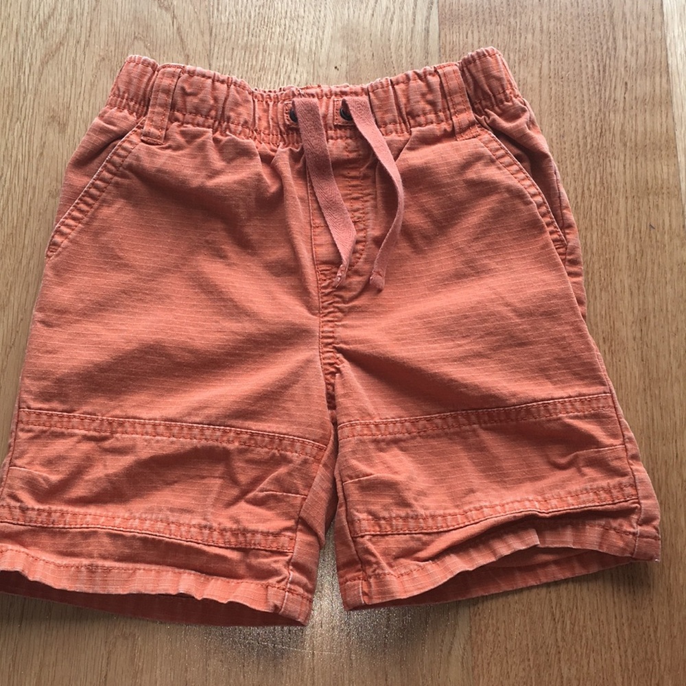 Used in great condition boys orange shorts. Size 2
